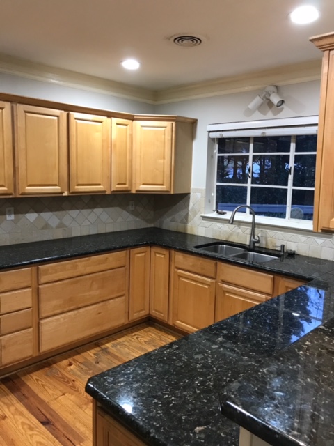 dated kitchen with 2-tier countertops and dark granite counters