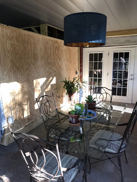screened porch with table and chairs