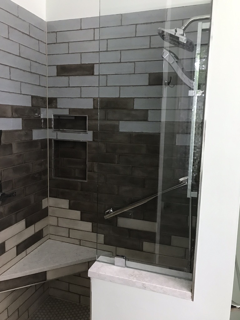 modern shower with corner shelf and grab bar
